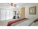 Cozy bedroom featuring a sliding glass door leading to an outdoor patio, wood-look floors, and ample closet space at 3822 W Euclid Ave, Tampa, FL 33629