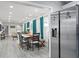 Open-concept dining room features a long table and views of living area, and a stainless refrigerator at 3822 W Euclid Ave, Tampa, FL 33629