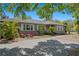 Welcoming one-story home featuring a cozy outdoor seating area and well-kept landscaping at 3822 W Euclid Ave, Tampa, FL 33629