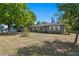 Charming single-story home featuring a well-maintained lawn and mature trees, under a clear blue sky at 3822 W Euclid Ave, Tampa, FL 33629