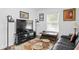Comfortable living room featuring a large TV, stylish lamps, and a patterned rug over light floors at 3822 W Euclid Ave, Tampa, FL 33629