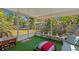 Inviting screened patio overlooking a lush backyard, furnished with a sofa and outdoor seating at 3822 W Euclid Ave, Tampa, FL 33629