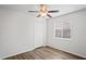 Bedroom showcasing updated flooring, a ceiling fan, and a window offering natural light at 402 Abigail Rd, Plant City, FL 33563