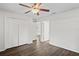 Bedroom featuring wood-look floors, a ceiling fan, and a spacious closet for storage at 402 Abigail Rd, Plant City, FL 33563