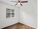 Bedroom with new floors, a ceiling fan, and a large window to let in natural light at 402 Abigail Rd, Plant City, FL 33563