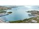 A stunning aerial view overlooking a vast ocean, revealing a boat dock with modern residences along the tranquil shore at 455 Alt 19 S Hwy # 81, Palm Harbor, FL 34683