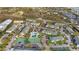 Aerial view of community featuring a pool, tennis courts, and lush landscaping at 455 Alt 19 S Hwy # 81, Palm Harbor, FL 34683
