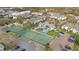 Aerial view of tennis courts, pool, parking, and beautifully landscaped condo buildings at 455 Alt 19 S Hwy # 81, Palm Harbor, FL 34683