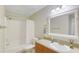 Clean bathroom with a shower-tub combo, vanity, and large mirror at 455 Alt 19 S Hwy # 81, Palm Harbor, FL 34683
