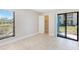 A cozy bedroom with large window and sliding glass doors that bring in a lot of light at 455 Alt 19 S Hwy # 81, Palm Harbor, FL 34683