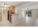 Bright living space with kitchen view, slider to patio, and tile flooring throughout at 455 Alt 19 S Hwy # 81, Palm Harbor, FL 34683