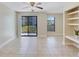 Bright living area with sliding glass doors, shelves, and tile floors, overlooking the exterior at 455 Alt 19 S Hwy # 81, Palm Harbor, FL 34683