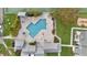 A stunning birds-eye view of the geometric pool area, lush green spaces and lounge areas at 455 Alt 19 S Hwy # 81, Palm Harbor, FL 34683