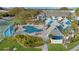 Relaxing pool area with comfortable lounge chairs, palm trees, and a jacuzzi for community residents at 455 Alt 19 S Hwy # 81, Palm Harbor, FL 34683