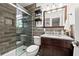 Modern bathroom with tiled shower, granite vanity and decorative fixtures at 4806 Bay Crest Dr, Tampa, FL 33615