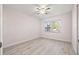 Bright and airy bedroom featuring wood-look flooring and a ceiling fan at 4806 Bay Crest Dr, Tampa, FL 33615