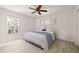 Bright bedroom featuring a ceiling fan, neutral paint, and wood-look flooring at 4806 Bay Crest Dr, Tampa, FL 33615