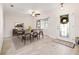 Dining room featuring tile floors, modern ceiling fan, large front window, and a decorative door at 4806 Bay Crest Dr, Tampa, FL 33615
