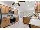 Kitchen with stainless steel appliances, stylish cabinets, white countertops, and eat-in breakfast bar at 4806 Bay Crest Dr, Tampa, FL 33615