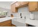 Well-lit kitchen featuring wood cabinets, white countertops, an apron sink, and stainless steel appliances at 4806 Bay Crest Dr, Tampa, FL 33615