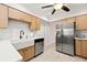 Bright kitchen featuring stainless steel appliances, farm sink, stylish cabinets, and white countertops at 4806 Bay Crest Dr, Tampa, FL 33615