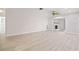 Spacious living room with light tile floors, and a fireplace with access to bathroom and other rooms at 4806 Bay Crest Dr, Tampa, FL 33615