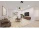 Bright living room with neutral decor, hardwood floors, and access to the backyard through sliding glass doors at 4806 Bay Crest Dr, Tampa, FL 33615