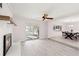 Comfortable living room with a brick fireplace, ceiling fan, tile floors, and sliding glass doors at 4806 Bay Crest Dr, Tampa, FL 33615