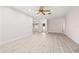 Open-concept living room with light tile floors, natural light, and a view of the front entry at 4806 Bay Crest Dr, Tampa, FL 33615
