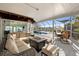 Covered outdoor patio with fireplace overlooking swimming pool and canal at 4806 Bay Crest Dr, Tampa, FL 33615