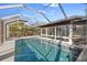 Inviting screened-in pool offers a refreshing escape and views of the lush backyard at 4806 Bay Crest Dr, Tampa, FL 33615