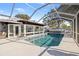 Outdoor swimming pool and lanai with a clear enclosure overlooking the waterway at 4806 Bay Crest Dr, Tampa, FL 33615