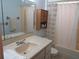 Clean bathroom featuring a vanity with mirror, storage cabinet, and shower with curtain at 4904 E River Hills Dr, Tampa, FL 33617