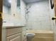 This bathroom features stylish marble-look tile, bathtub, and modern fixtures at 4904 E River Hills Dr, Tampa, FL 33617