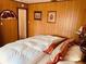 Relaxing bedroom featuring traditional wood paneling and vintage decor accents at 4904 E River Hills Dr, Tampa, FL 33617