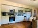Bright kitchen with white appliances and cabinetry and a tile backsplash at 4904 E River Hills Dr, Tampa, FL 33617