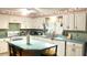 Bright kitchen with plenty of natural light, featuring an island with seating at 4904 E River Hills Dr, Tampa, FL 33617