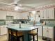 Kitchen featuring lots of cabinets and counter space, dishwasher, range and large island with seating at 4904 E River Hills Dr, Tampa, FL 33617