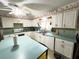Kitchen featuring lots of cabinets and counter space, dishwasher, range and large island at 4904 E River Hills Dr, Tampa, FL 33617