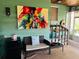Cozy sitting area with wicker furniture, perfect for relaxing with a book, colorful decorative painting at 4904 E River Hills Dr, Tampa, FL 33617