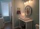 Well-lit bathroom with a vanity, decorative mirror, and stylish fixtures at 506 65Th St, Holmes Beach, FL 34217