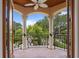 Balcony features tile flooring, ornate pillars, and overlooks a beautifully landscaped backyard at 608 Orange Ave, Clearwater, FL 33756