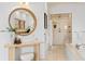 Bright bathroom with a large vanity, round mirror, walk-in shower, and soaking tub at 608 Orange Ave, Clearwater, FL 33756