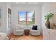 Sitting area with matching armchairs and large window with a view of the neighborhood at 608 Orange Ave, Clearwater, FL 33756