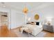 Bright bedroom features decorative light fixture, matching bedside tables and a large closet at 608 Orange Ave, Clearwater, FL 33756