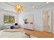 Bright bedroom featuring hardwood floors, decorative light fixture, and sitting area at 608 Orange Ave, Clearwater, FL 33756