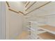 Walk-in closet with custom shelving and tile flooring, perfect for organized storage at 608 Orange Ave, Clearwater, FL 33756