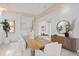 Bright dining room features a wooden table, stone floors, and modern decorations at 608 Orange Ave, Clearwater, FL 33756