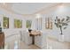 Bright dining room with large windows, modern decor, a statement art piece, and marble floors at 608 Orange Ave, Clearwater, FL 33756