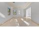 Spacious, sunlit empty room with large windows, tile floors, and elegant moldings, ready for customization at 608 Orange Ave, Clearwater, FL 33756